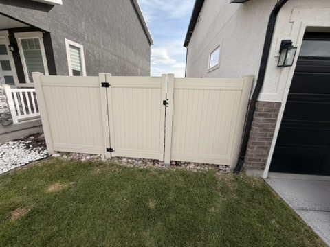 Vinyl fence before the access upgrade, with a single narrow gate