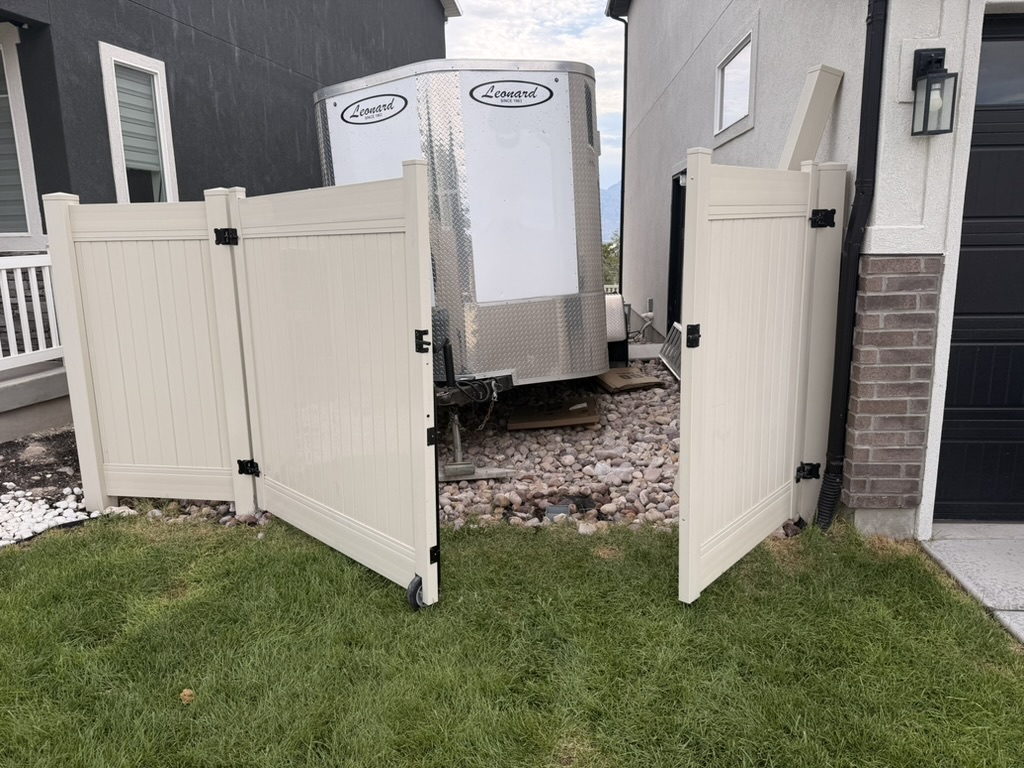 Completed vinyl double gate opened to provide wide side-yard access